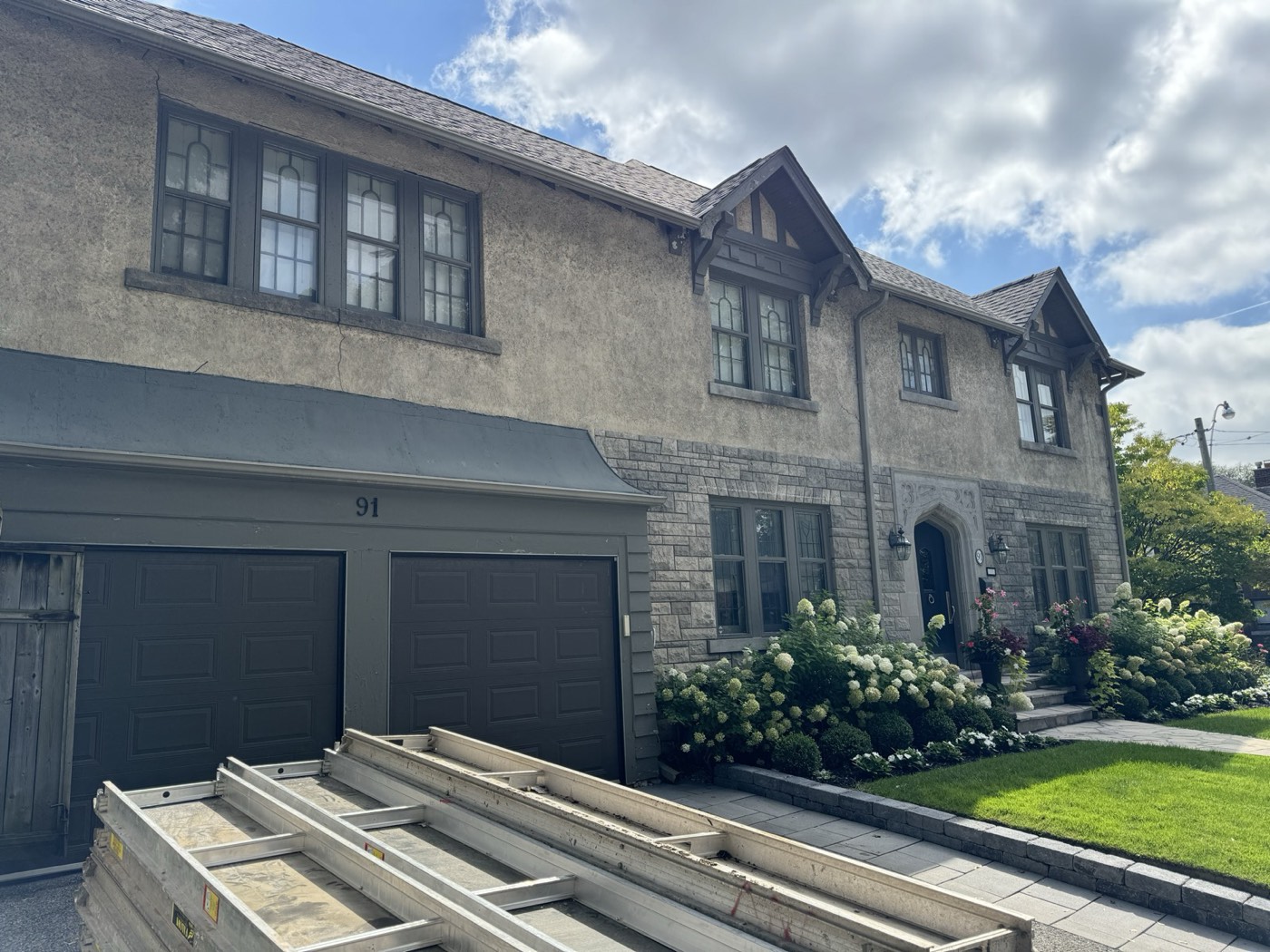 The same Toronto house after stucco refinishing in a grey finish