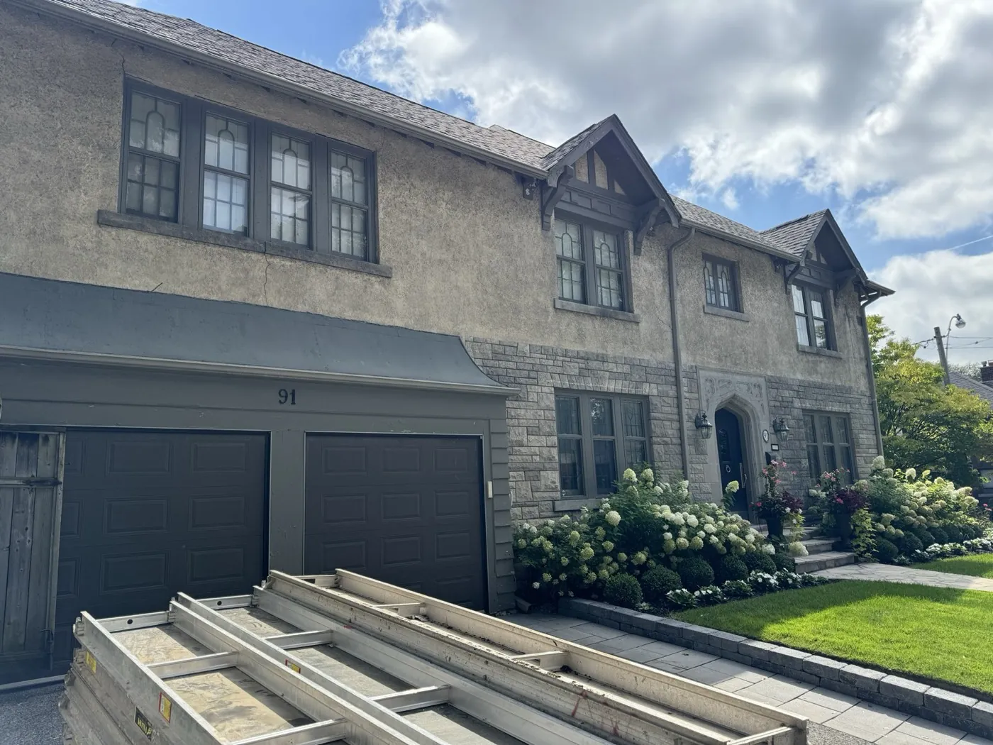 The same Toronto house after stucco refinishing in a grey finish