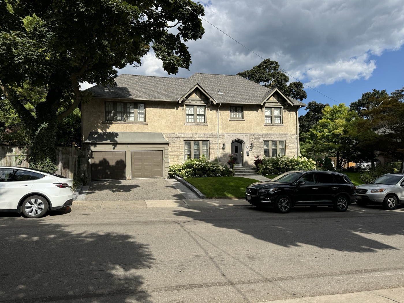 Toronto stucco house before refinishing, showing the original weathered beige finish