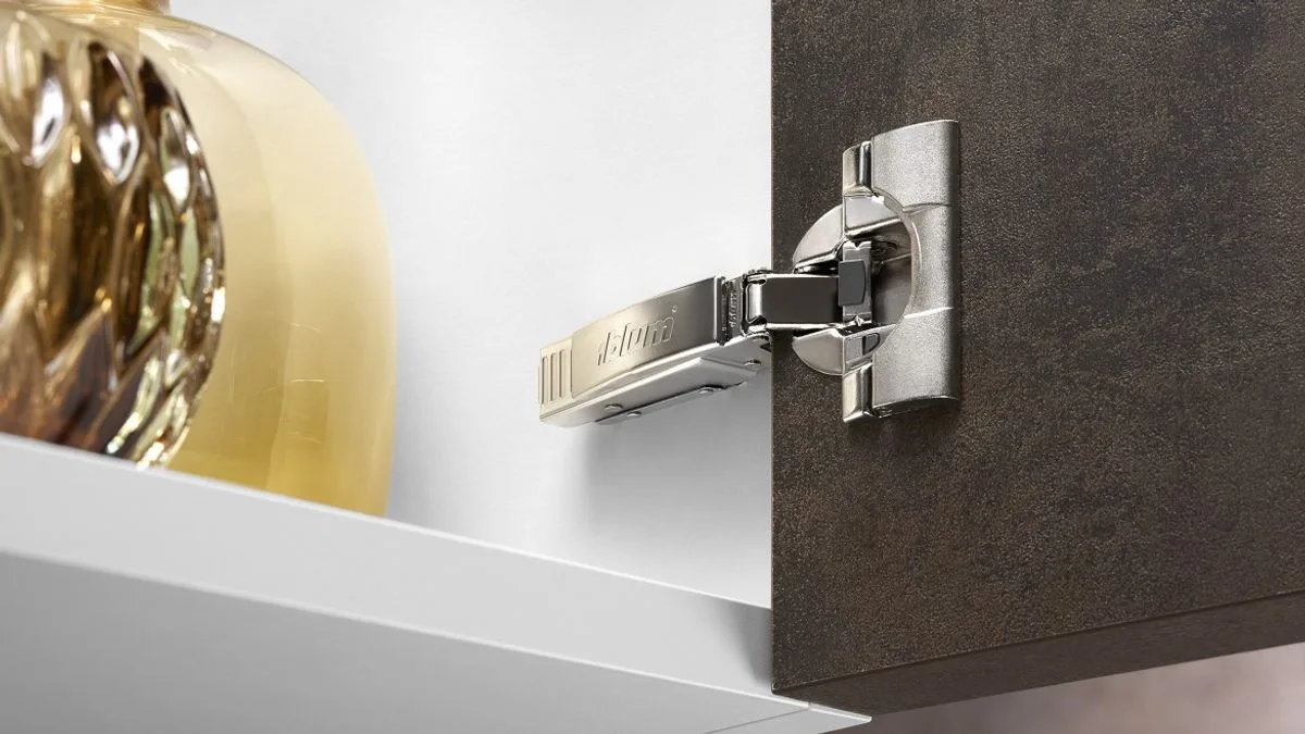 Close-up of a Blum CLIP top hinge showing its adjustment screws